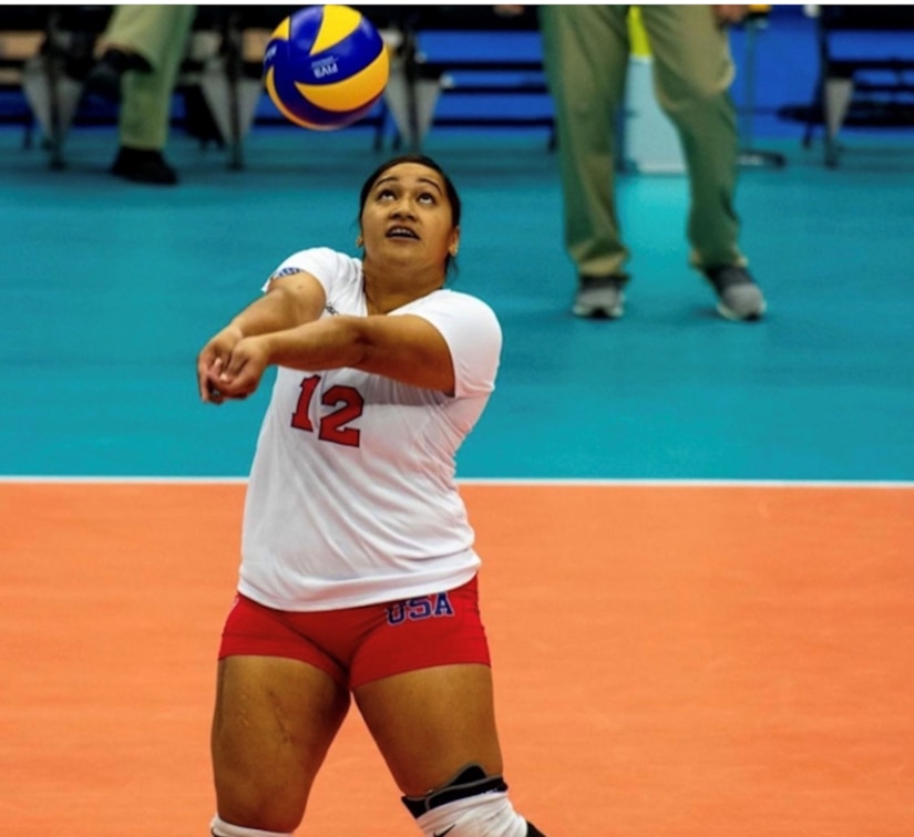 A woman prepares to hit a volleyball.