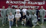 Soldiers from Virginia Officer Candidate School Class 54 pose with cadre and members of the Blackstone Volunteer Fire Department Aug. 25, 2012 after applying a fresh coat of paint on the walls of the station’s hallways. The project was part of the Phase Two requirements of their course curriculum. (Contributed photo)