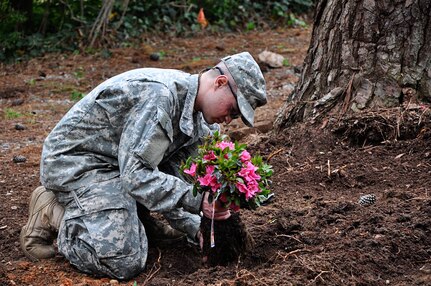 Officer candidates from Class 55 of the Virginia National Guard’s Officer Candidate School clear debris and work on landscape improvements May 4, 2013, as part of their class community project in Richmond, Va. (Photo by Staff Sgt. Terra C. Gatti, Virginia Guard Public Affairs)