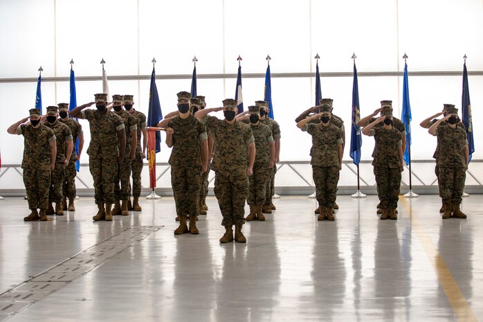 U.S. Marines salute during the playing of the National Anthem at the Marine Corps Air Station New River sergeant major relief and appointment ceremony at the Center for Naval Aviation Technical Training on MCAS New River, North Carolina, April 16, 2021. The relief and appointment ceremony symbolized the passing of responsibilities and duties from Sgt. Maj. Carlos A. Orjuela to the incoming sergeant major, Sgt. Maj. Douglas W. Gerhardt. (U.S. Marine Corps Lance Cpl. Isaiah Gomez)