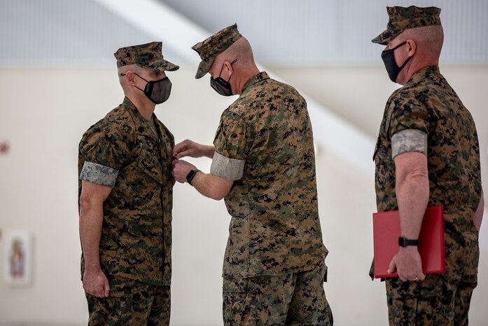 U.S. Marine Corps Sgt. Maj. Carlos A. Orjuela, left, the outgoing sergeant major for Marine Corps Air Station New River is awarded  during the New River sergeant major relief and appointment ceremony at the Center for Naval Aviation Technical Training on MCAS New River, North Carolina, April 16, 2021. The relief and appointment ceremony symbolized the passing of responsibilities and duties from Orjuela to the incoming sergeant major, Sgt. Maj. Douglas W. Gerhardt. (U.S. Marine Corps Lance Cpl. Isaiah Gomez)