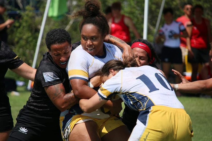 Women play rugby.