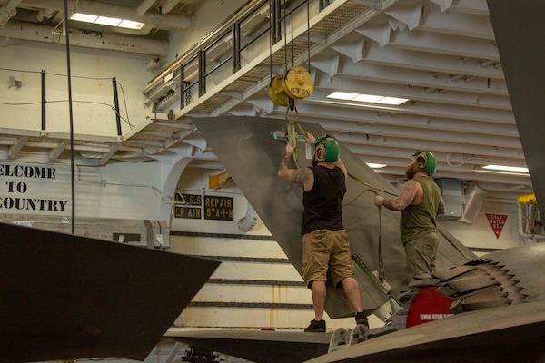 Mechanics perform repairs on an F-35B aircraft