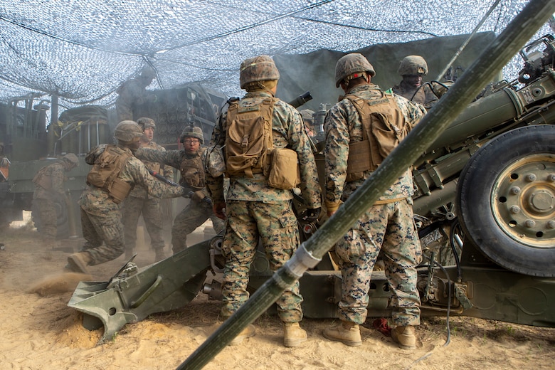U.S. Marines with 1st Battalion, 10th Marine Regiment, 2d Marine Division (2d MARDIV), load an 155mm round into an M777 Howitzer during Exercise Rolling Thunder 21.2 on Fort Bragg, N.C, April 20, 2021. This is a live-fire artillery exercise where 10th Marines employed distributed fires via simulated Expeditionary Advanced Bases (EAB’s). The training increased 2d MARDIV’s combat readiness against a peer competitor. (U.S. Marine Corps photo by Pfc. Sarah Pysher)