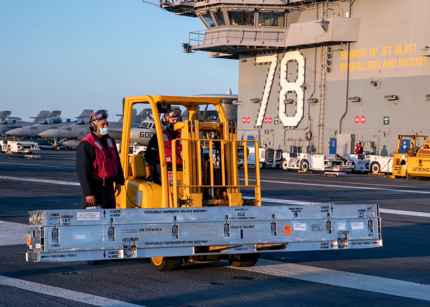 Sailors assigned USS Gerald R. Ford (CVN 78) weapons department move ordnance during the ship's first-ever vertical replenishment ammunition off-load on the flight deck, April 21,
