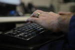 Petty Officer 2nd Class Andrew Guthrie, an information systems technician at the Base Seattle Electronic Support Detachment, works at his desk at Coast Guard Base Seattle, March 3, 2015. Guthrie was one of three Coast Guard members presented with the Copernicus Award in 2015, for his work in fiscal year 2014. (U.S. Coast Guard photo by Petty Officer 3rd Class Amanda Norcross)