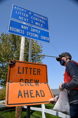 Lt. Cmdr. Brian Bieber, project officer, assigned to Naval Supply Systems Command (NAVSUP) Business Systems Center (BSC), removes trash and debris from a two-mile stretch of road in Mechanicsburg as part of the Pennsylvania Department of Transportation (PennDOT) state-wide Adopt A Highway program.