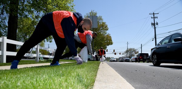 Lt. j.g. Carlos Londono, Lt. Terry Hogan, and Capt. Gene Cash, commanding officer, Naval Supply Systems Command (NAVSUP) Business Systems Center (BSC), remove trash and debris from a two-mile stretch of road in Mechanicsburg as part of the Pennsylvania Department of Transportation (PennDOT) state-wide Adopt A Highway program.