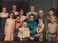 Large family of 14 poses for photo