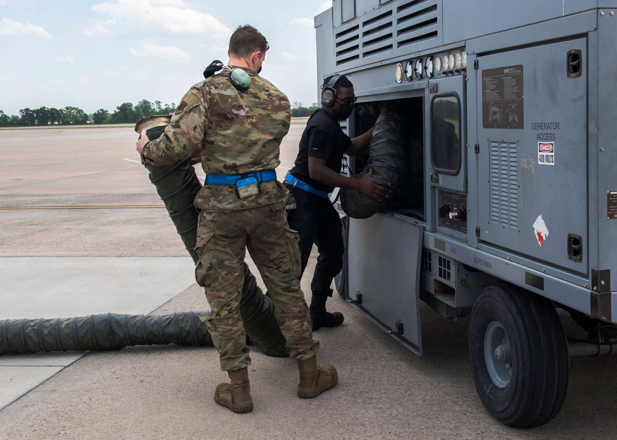Airman First Class Kyle Woodson, right, and Senior Airman Paul Hearon, 334th Fighter Squadron avionics specialists, put away a Thor cart at Seymour Johnson Air Force Base, North Carolina, April 21, 2021.