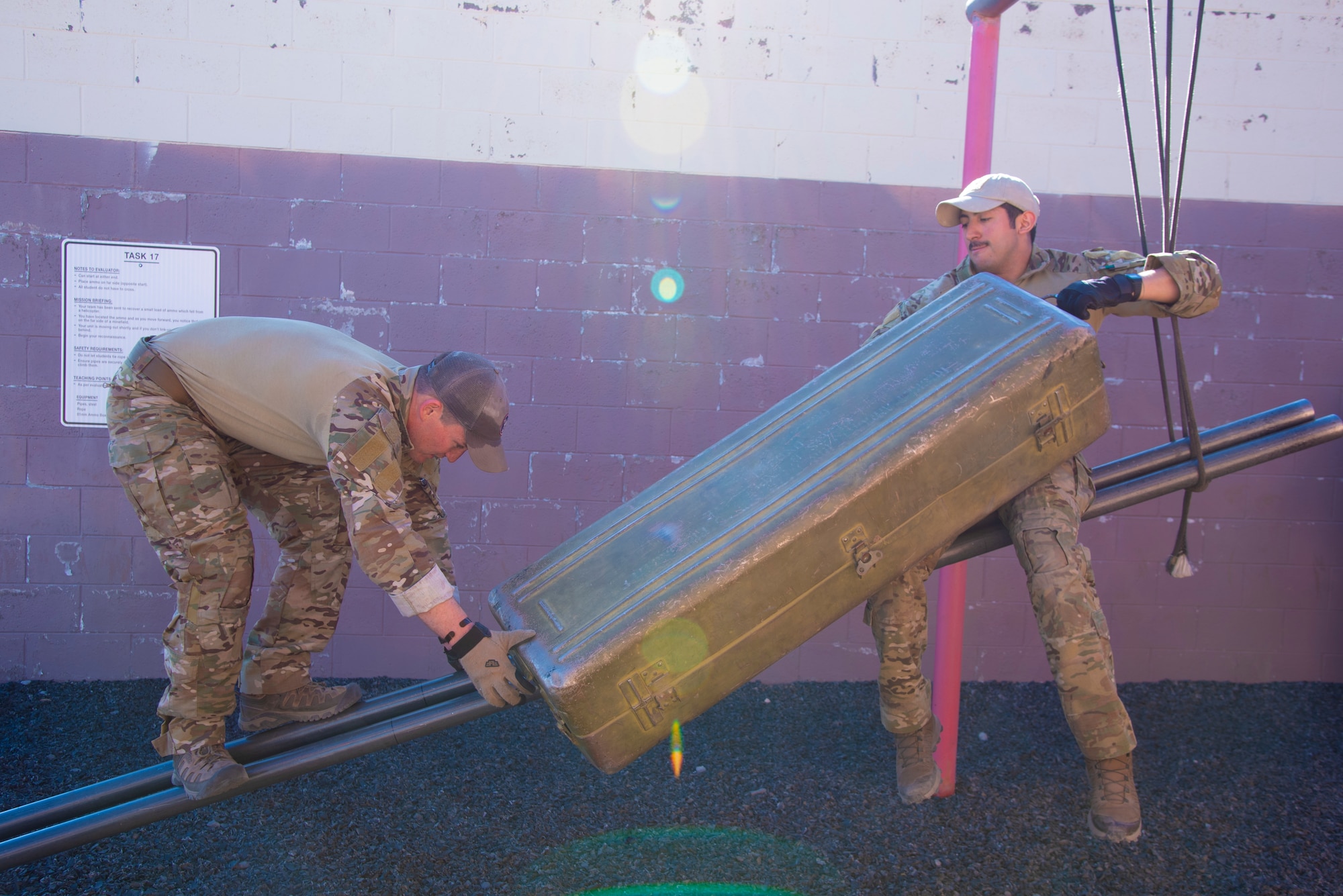 Two U.S. Air Force Tactical Air Control Party specialists go through the leadership reaction course during the 2021 Wraith Challenge, April 20, 2021, on Fort Bliss, Texas. The leadership reaction course challenge tested their problem solving and teamwork ability to maneuver themselves and equipment through different sets of obstacles and scenarios. (U.S. Air Force photo by Airman 1st Class Jessica Sanchez)
