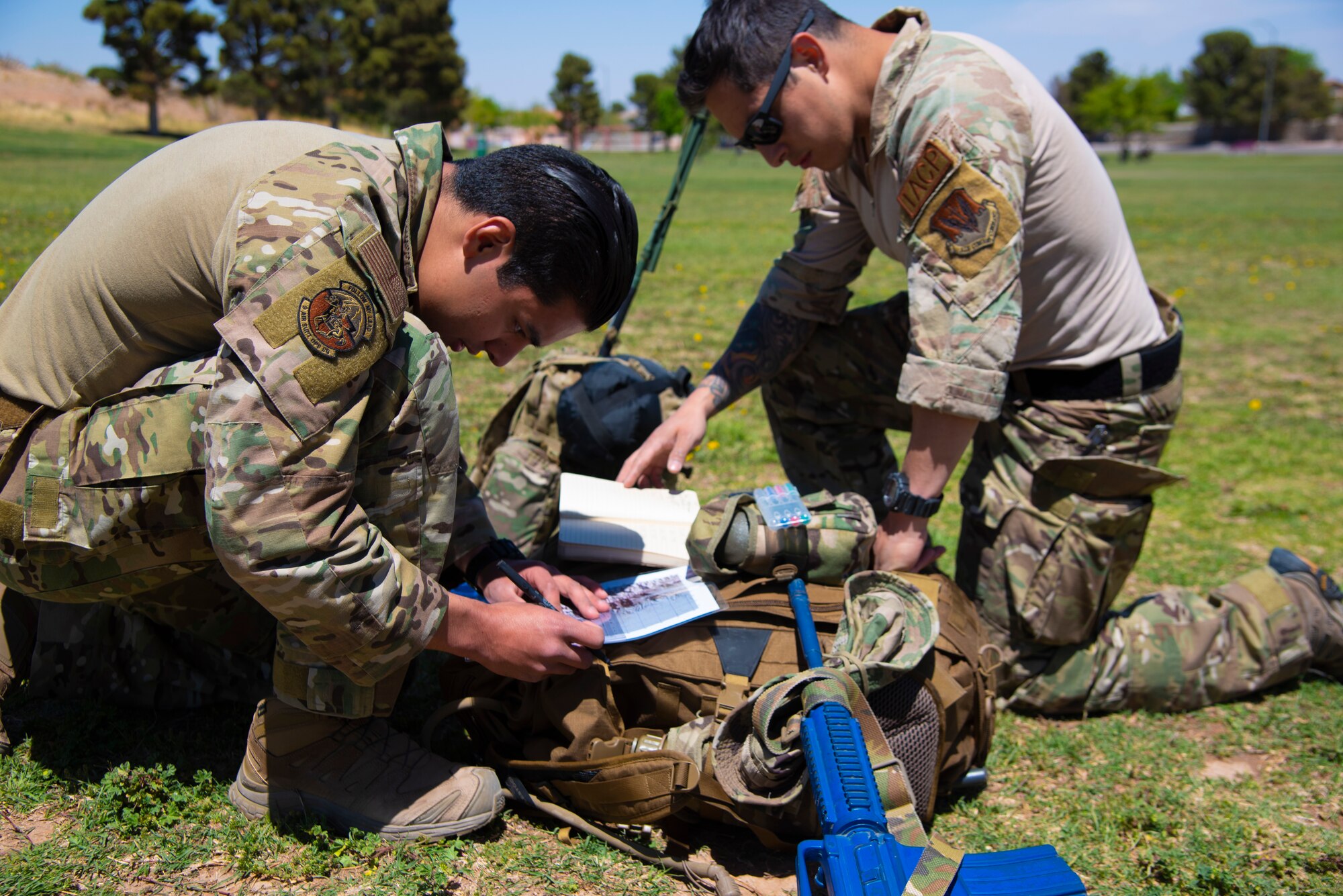 Two U.S. Air Force Tactical Air Control Party specialists plot a navigation course during the 2021 Wraith Challenge, April 21, 2021, at Chuck Heinrich Memorial Park, Texas. Participants were given the location of three points and time to plan a route to find them--using nothing but a map and compass. (U.S. Air Force photo by Airman 1st Class Jessica Sanchez)