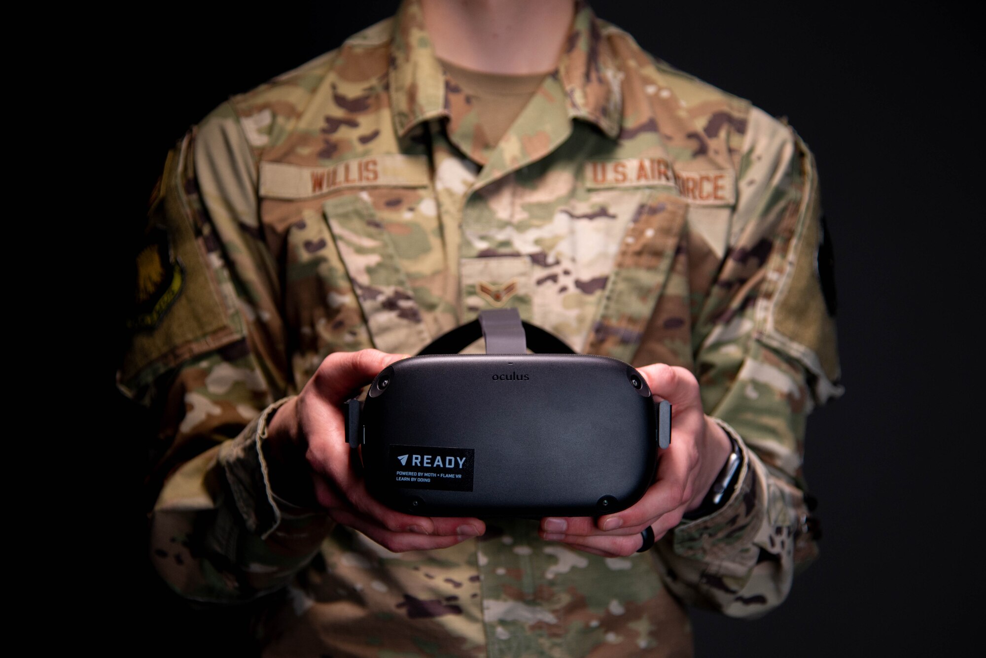 Airman 1st Class Zachary Willis, 22nd Wing Staff Agencies public affairs, holds the headset utilized for virtual reality suicide prevention training April 15, 2021, at McConnell Air Force Base, Kansas. The 30-minute training provides a fully immersive experience that involves Airmen wearing a headset and entering into a virtual training scenario where they interact with an Airman in distress. Currently, the VR training is approved to be one of four options Airmen can choose to fulfill their annual suicide prevention training.  (U.S. Air Force photo by Senior Airman Nilsa Garcia)