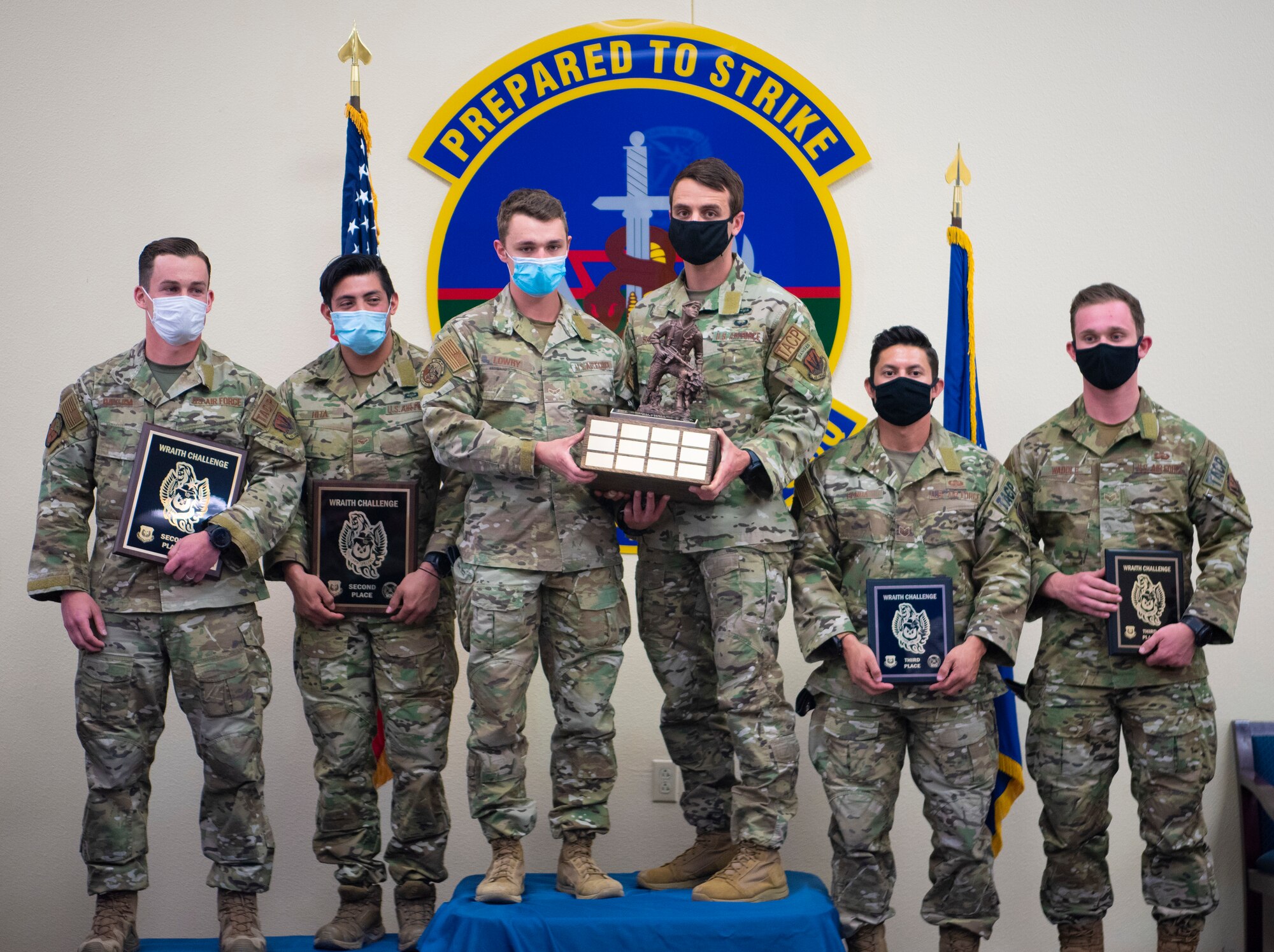 (Middle left) Airman 1st Class Robert Lowry and (middle right) 1st Lt. Joshua Sams, 9th Air Support Operations Squadron Tactical Air Control Party stand on the winners’ podium with 2nd and 3rd place winners after winning the 2021 Wraith Challenge, April 23, 2021, on Fort Bliss, Texas. The Wraith Challenge is an annual 3rd Air Support Operations Group competition which pits two-man teams of the best-of-the-best from Air Force Special Warfare TACP against each other in physical, mental and tactical skills challenges.  (U.S. Air Photo by Airman 1st Class Jessica Sanchez)