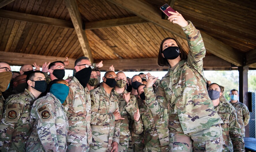 Chief Master Sgt. of the Air Force JoAnne S. Bass takes a selfie with Airmen from the 2nd Communications Squadron during her visit to Barksdale Air Force Base, Louisiana, April 22, 2021. Bass spent time with Airmen from across the installation, learning about their role in the mission of providing the nation with global strike capabilities. (U.S. Air Force photo by Airman 1st Class Jacob B. Wrightsman)