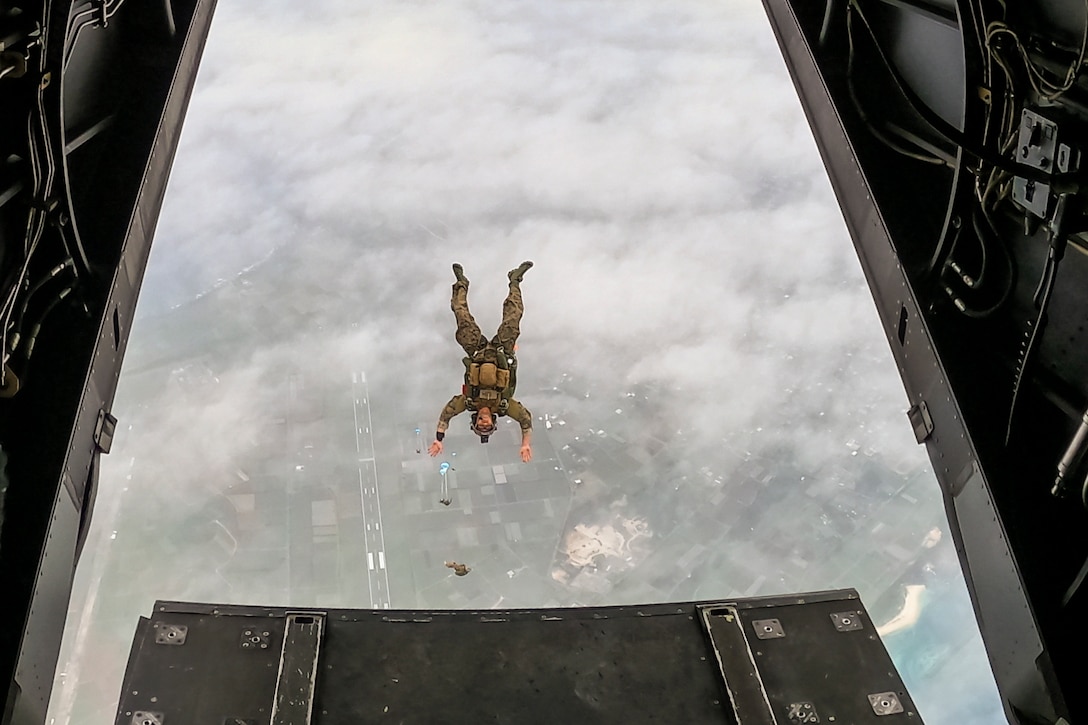 Marines freefall after jumping from an airborne aircraft.