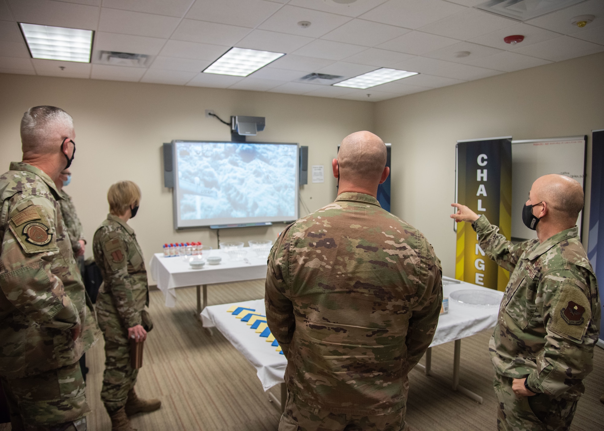 U.S. Air Force Capt. Mathew Riddle, 315th Training Squadron officer in charge of the intelligence officer course team, center, shows Col. Andres Nazario, 17th Training Wing commander, right, the recreation room in the Consolidated Learning Center on Goodfellow Air Force Base, Texas, April 15, 2021. This room was used as part of the tour conducted at the new intelligence virtual learning center in the CLC. (U.S. Air Force photo by Staff Sgt. Tyrell Hall)