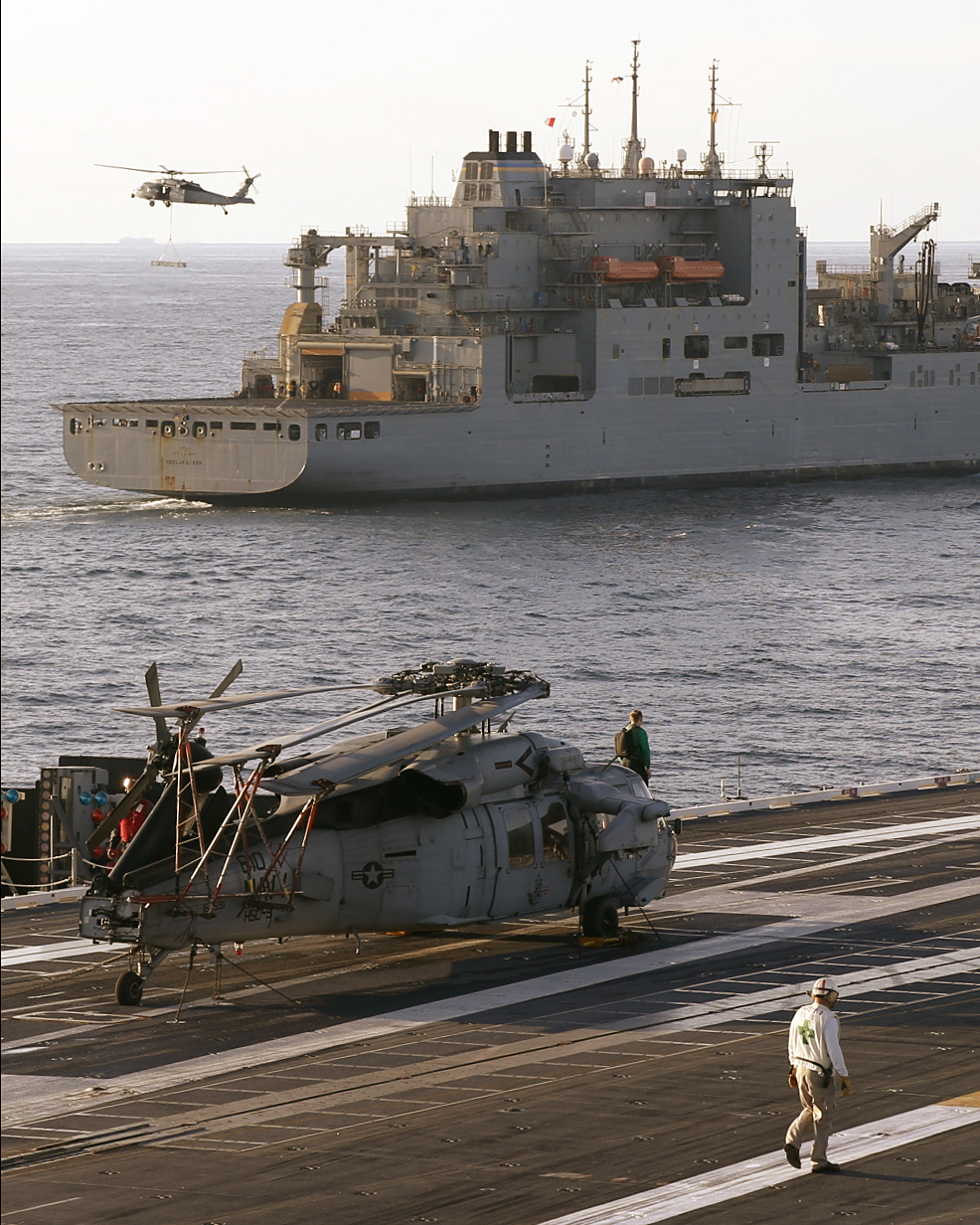 AN MH-60S Nighthawk helicopter delivers ordnance to USNS Medgar Evers (T-AKE 13) during the first-ever vertical replenishment ammunition offload onboard carrier USS Gerald R. Ford (CVN 78), April 21, 2021.