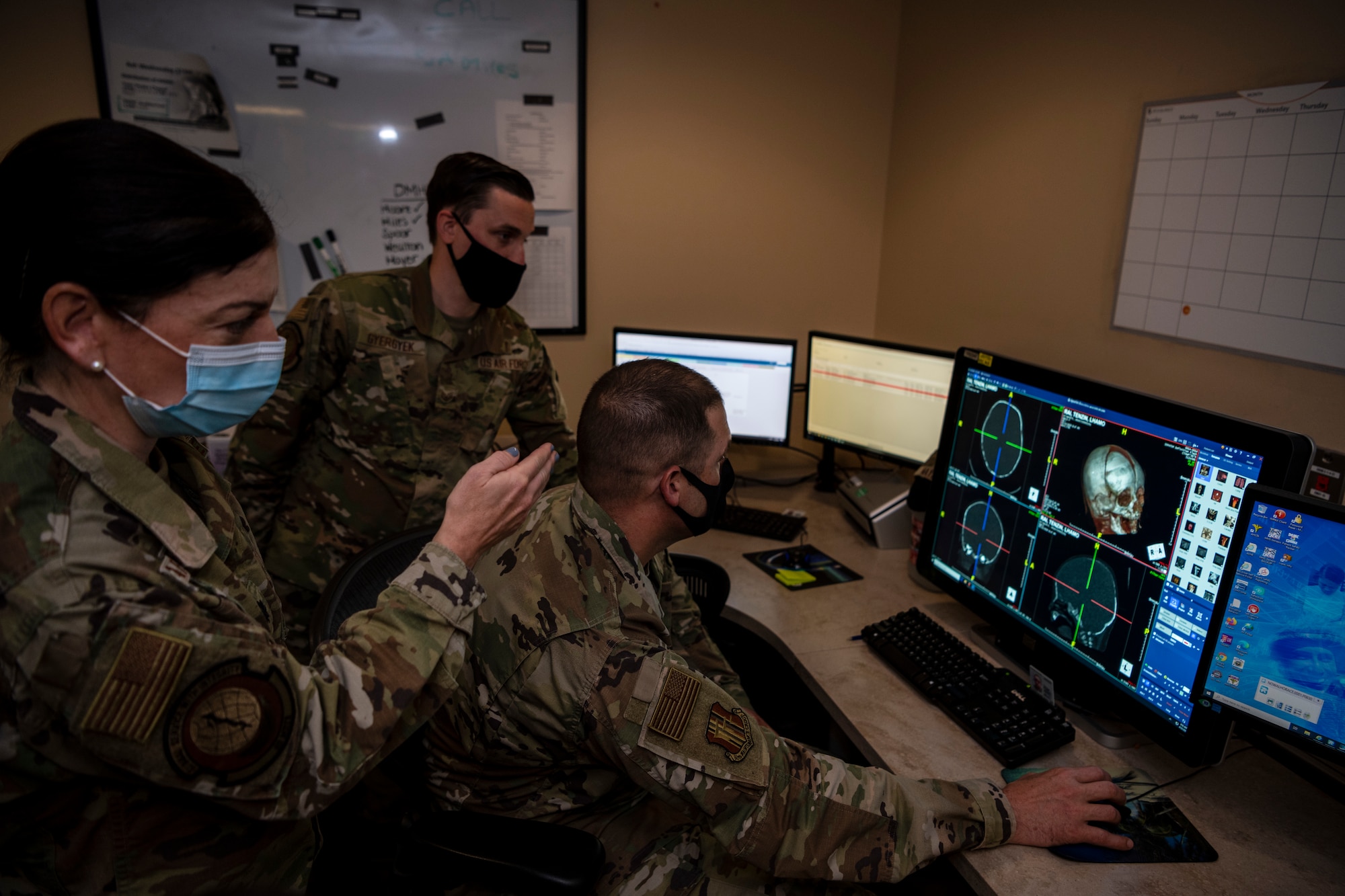 Airmen show other Airmen with higher rank images on the computer.