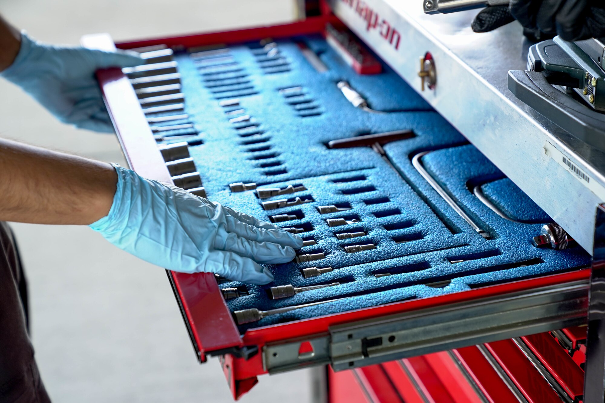 Airmen from the 15th and 154th Aircraft Maintenance Squadron take inventory of their tools before performing routine maintenance checks on an F-22 Raptor on the flightline at Joint Base Pearl Harbor-Hickam, Hawaii, March 17, 2021. The 154th AMXS works alongside the 15th AMXS providing maintenance support including inspection and repair, fuels, electrical, environmental, hydraulic and propulsion systems maintenance.  (U.S. Air Force photo by Airman 1st Class Makensie Cooper)