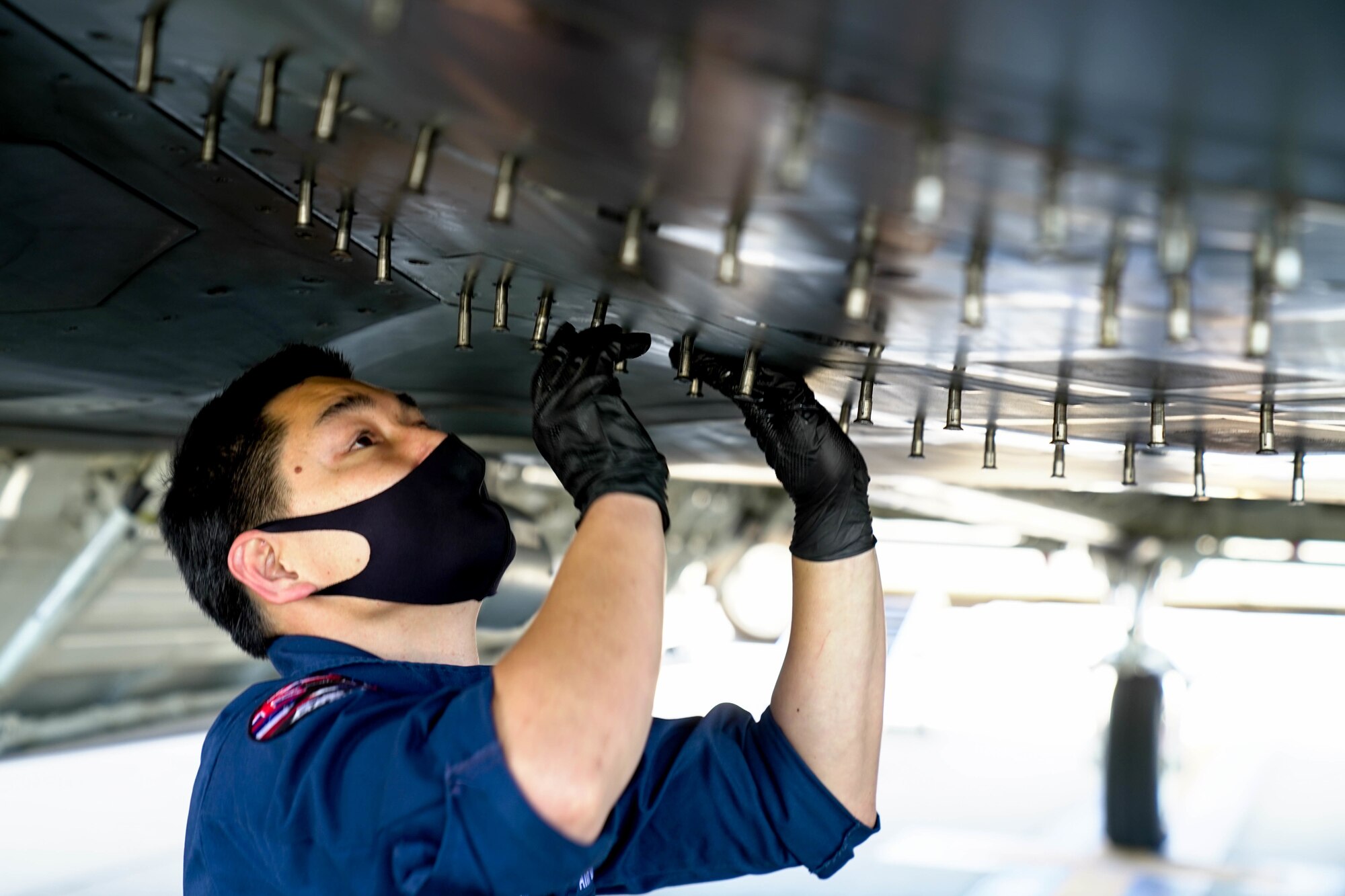 Senior Airman Cody Sonomura, 154th Aircraft Maintenance Squadron crew chief, performs routine maintenance checks on an F-22 Raptor on the flightline at Joint Base Pearl Harbor-Hickam, Hawaii, March 17, 2021. The 15th AMXS and the 154th AMXS work together to support the F-22 Raptor mission by performing aircraft inspections, servicing, launch and recovery, and maintenance repair actions for all assigned aircraft. (U.S. Air Force photo by Airman 1st Class Makensie Cooper)