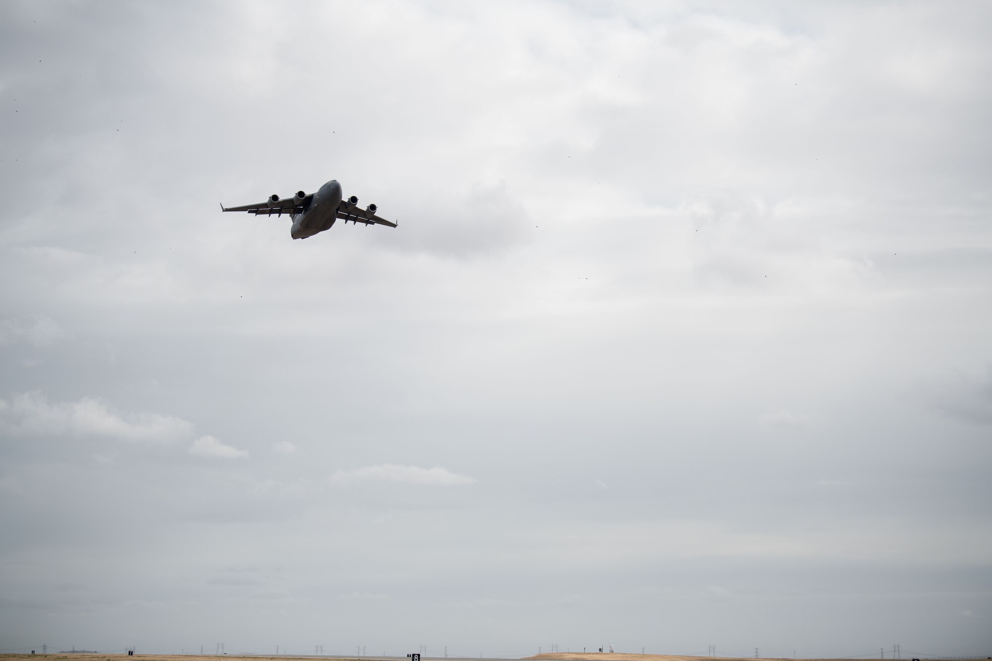 A C-17 aircraft flies upward over Travis AFB, Calif.