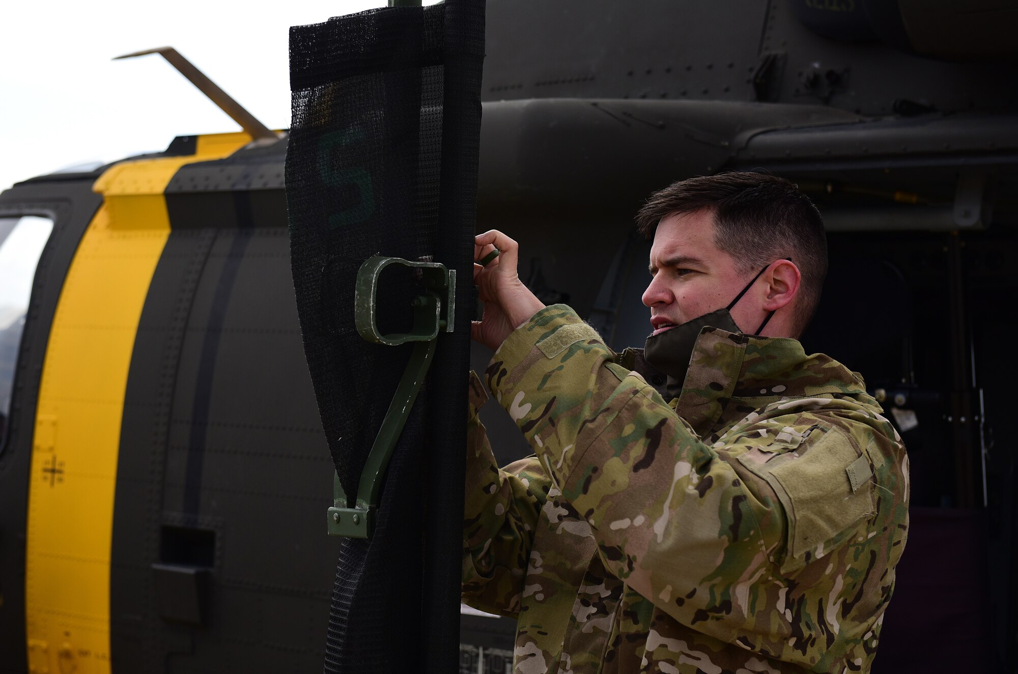 U.S. Army Staff Sgt. Nathan Hood, 3-2 General Support Aviation Battalion flight medic, Camp Humphreys, Republic of Korea, prepares a litter for demonstration during a joint medical evacuation training event at Kunsan Air Base, Republic of Korea, April 13, 2021. Military working dog teams from the 8th Security Forces Squadron participated in the first joint medevac training exercise with the units from Camp Humphreys to observe and calculate the steps needed to properly execute a medevac for MWDs and their handlers as well as reevaluate and develop processes for continuity and quick action responses in these kinds of scenarios. (U.S. Air Force photo by Senior Airman Suzie Plotnikov)