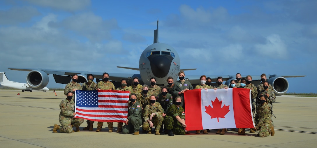 group photo of people in front of an aircraft