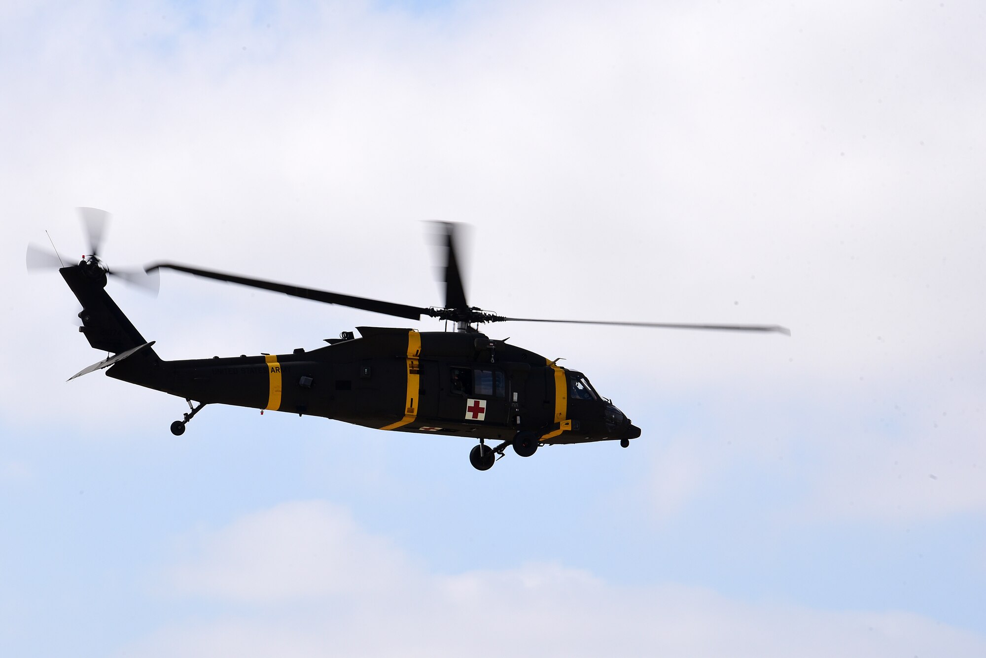 A U.S. Army HH-60M Black Hawk helicopter hovers over the flightline during a joint medical evacuation training exercise at Kunsan Air Base, Republic of Korea, April 13, 2021. Military working dog teams from the 8th Security Forces Squadron participated in the first joint medevac training exercise with the units from Camp Humphreys, to observe and calculate the steps needed to properly execute a medevac for MWDs and their handlers as well as reevaluate and develop processes for continuity and quick action responses in these kinds of scenarios. (U.S. Air Force photo by Senior Airman Suzie Plotnikov)