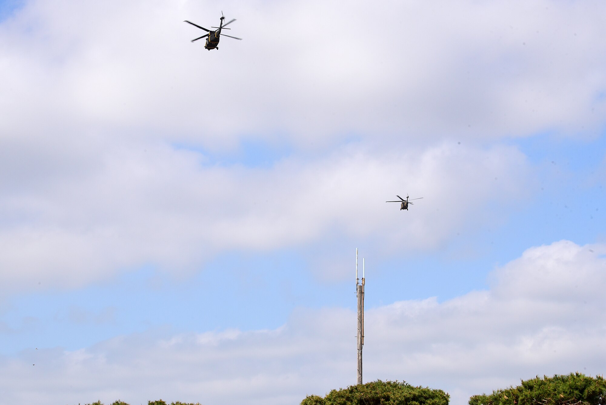 Two U.S. Army HH-60M Black Hawk helicopters fly back to Camp Humphreys, Republic of Korea, during a joint medical evacuation training event at Kunsan Air Base, Republic of Korea, April 13, 2021. Teams from the 8th Security Forces Squadron military working dogs participated in the first joint medevac training exercise with the units from Camp Humphreys to observe and calculate the steps needed to properly execute a medevac for MWDs and their handlers as well as reevaluate and develop processes for continuity and quick action responses in these kinds of scenarios. (U.S. Air Force photo by Senior Airman Suzie Plotnikov)