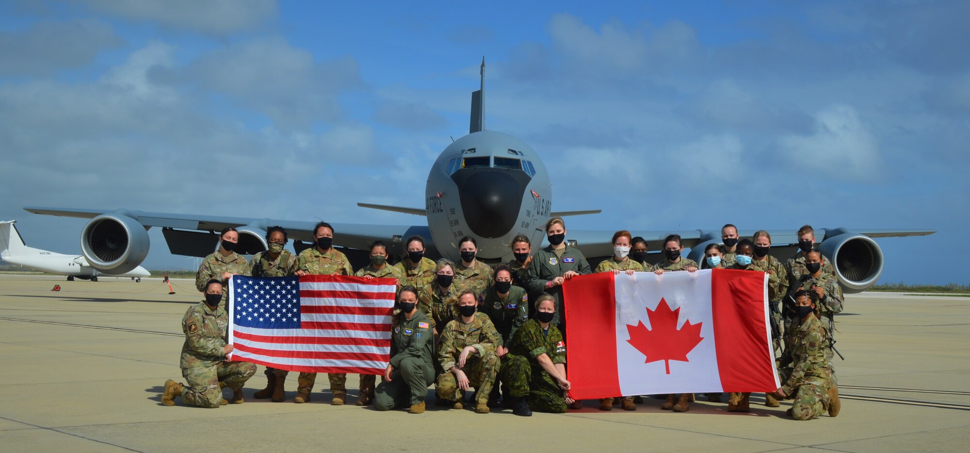 group photo of people in front of an aircraft