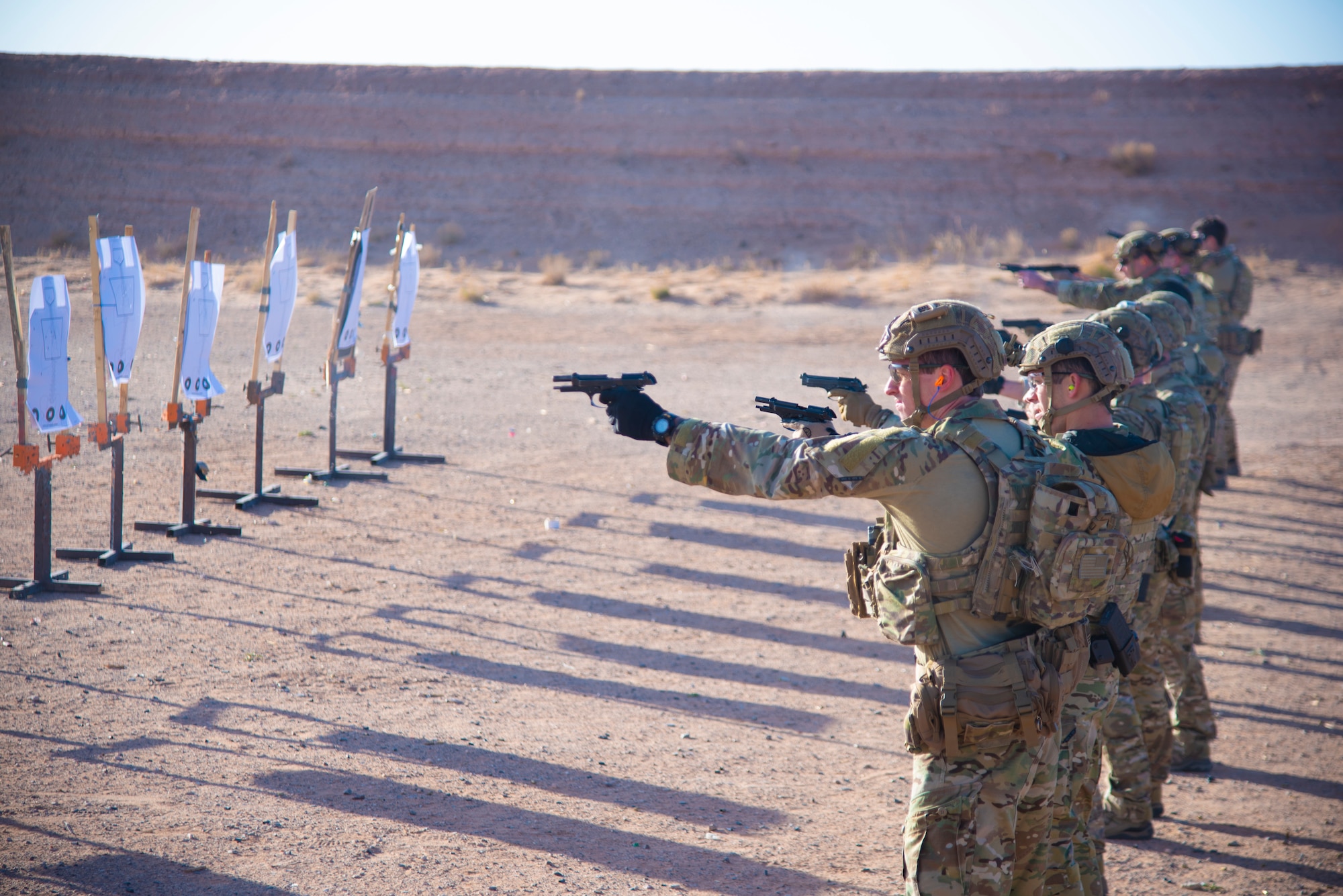 U.S. Air Force Tactical Air Control Party specialists shoot a Beretta M-9 during the 2021 Wraith Challenge, April 21, 2021, on Fort Bliss Rod and Gun Club, Texas. The TACP specialists went through the Navy qualification course of fire to test their firing ability in nonstandard positions. (U.S. Air Force photo by Airman 1st Class Jessica Sanchez)