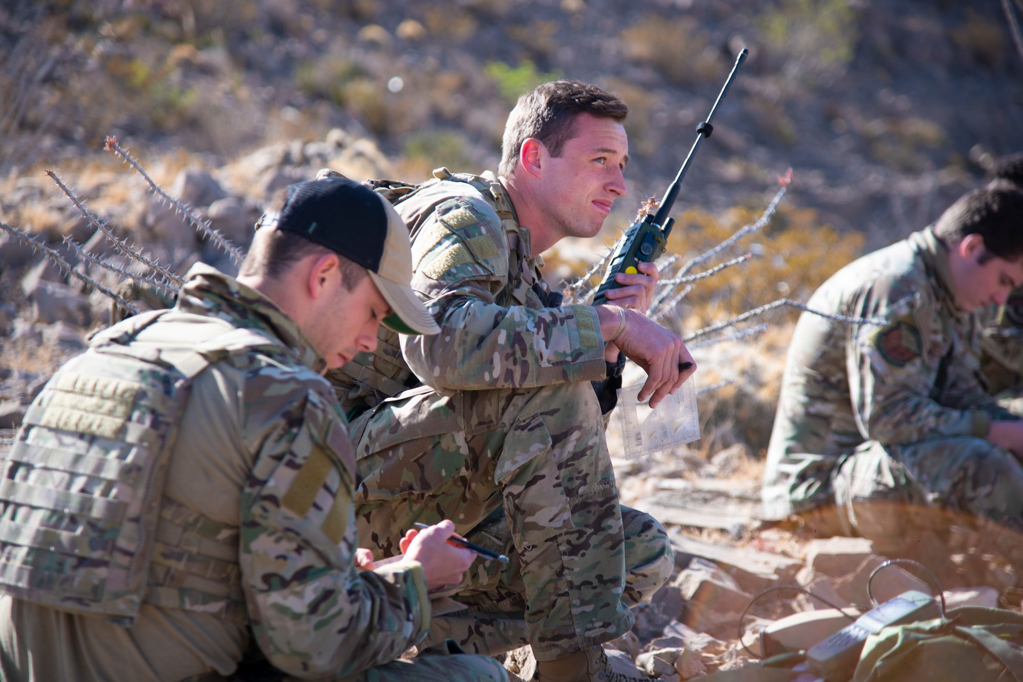 Two U.S. Air Force Tactical Air Control Party specialists communicate with a U.S. Army UH-64 Apache Helicopter during the 2021 Wraith Challenge, April 22, 2021, on Fort Bliss, Texas. TACP must be able to effectively communicate and command aircraft to defend friendly forces or attach enemy positions.  (U.S. Air Force photo by Airman 1st Class Jessica Sanchez)