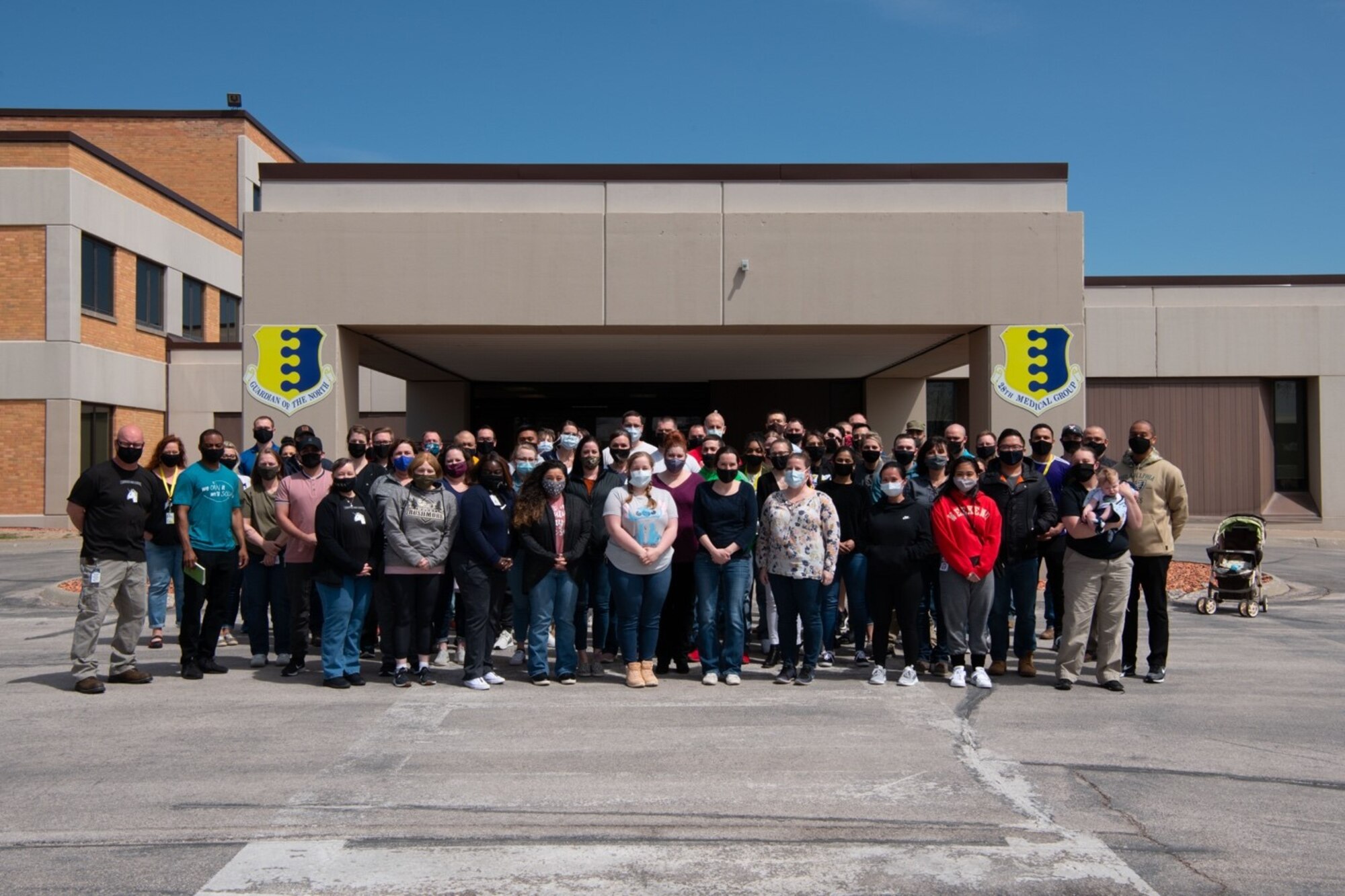 Staff from the 28th Medical Group pose for a photo outside of the medical facility after the launch of the new electronic health record system, MHS Genesis, at Ellsworth Air Force Base, S.D., April 24, 2021.