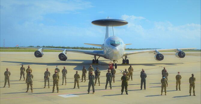 group photo of people in front of aircraft