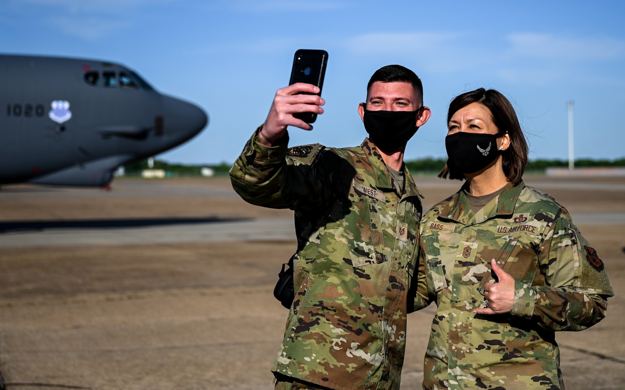 Chief Master Sgt. of the Air Force JoAnne S. Bass and Technical Sgt. Austin West, 2nd Aircraft Maintenance Squadron instrument flight control systems craftsman, pose for a selfie during a tour of Barksdale Air Force Base, Louisiana, April 21, 2021. West was recognized for being a master technician from the 96th Aircraft Maintenance Unit. (U.S. Air Force photo by Senior Airman Christina Graves)