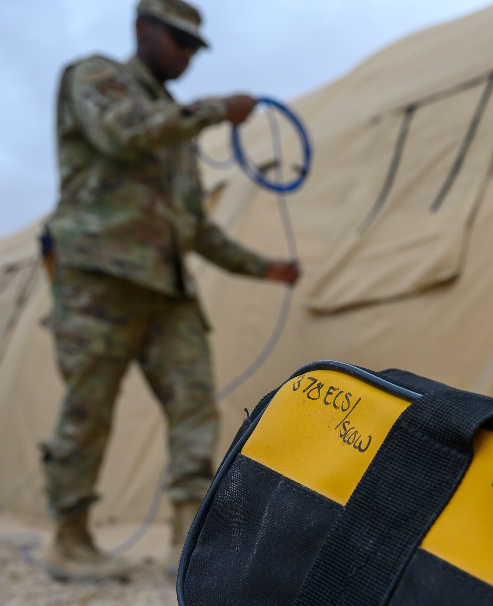 Airman 1st Class Isaiah Lipscomb, 378th Expeditionary Communications Squadron Cable and Antenna Maintenance technician, prepares new wires for use during an update to the base Wi-Fi, Prince Sultan Air Base, Kingdom of Saudi Arabia, April 17, 2021. The communications team has been upgrading Wi-Fi connectivity at PSAB and increasing the number of access points. The Wi-Fi network serves to improve quality of life for deployed members and their ability to contact family and loved ones at home. (U.S. Air Force Senior Airman Samuel Earick)