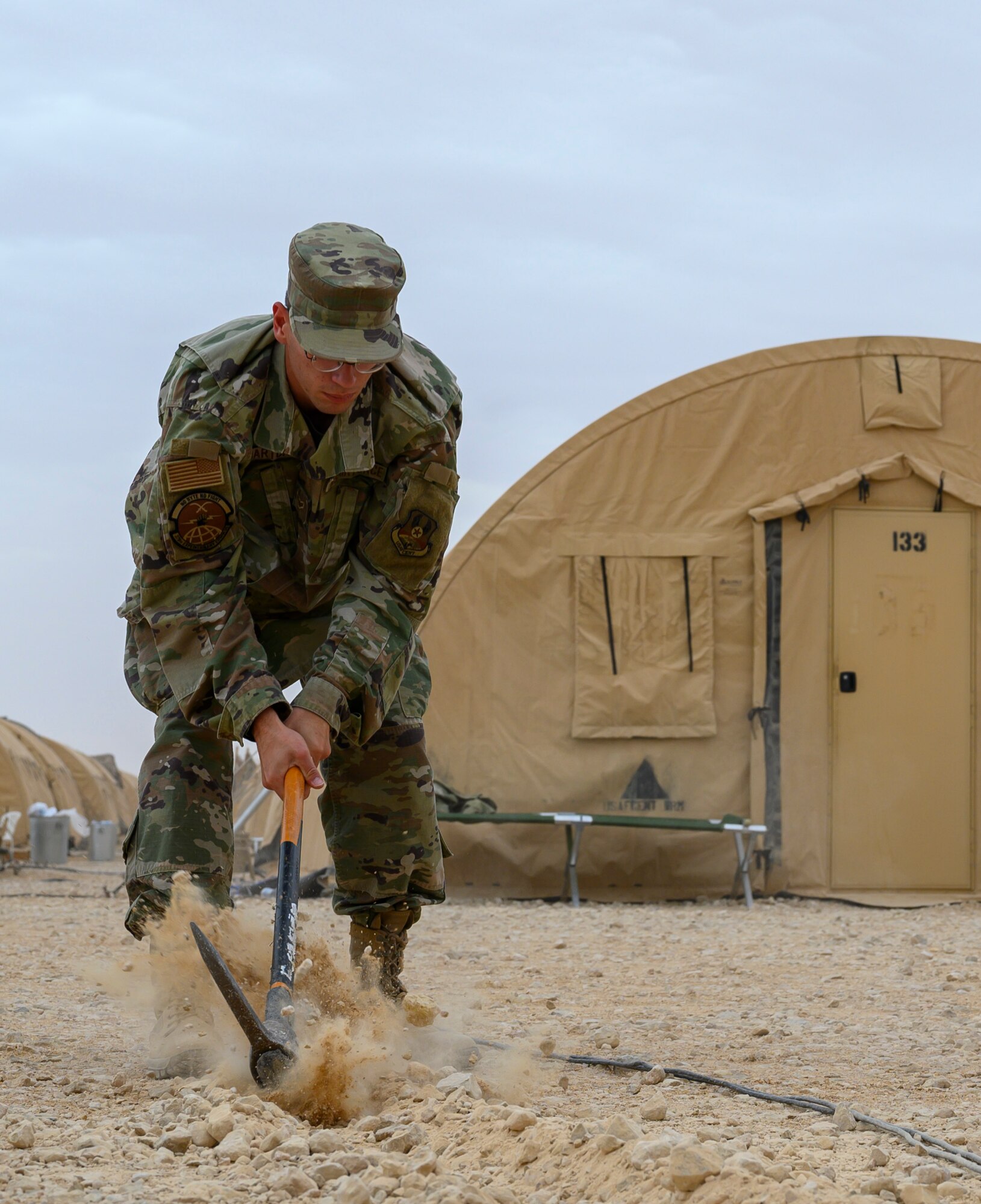 Airman 1st Class Quinn Barton, 378th Expeditionary Communications Squadron Cable and Antenna Maintenance technician, digs a trench to bury wires during an update to the base Wi-Fi, Prince Sultan Air Base, Kingdom of Saudi Arabia, April 17, 2021. The communications team has been upgrading Wi-Fi connectivity at PSAB and increasing the number of access points. The Wi-Fi network serves to improve quality of life for deployed members and their ability to contact family and loved ones at home. (U.S. Air Force Senior Airman Samuel Earick)