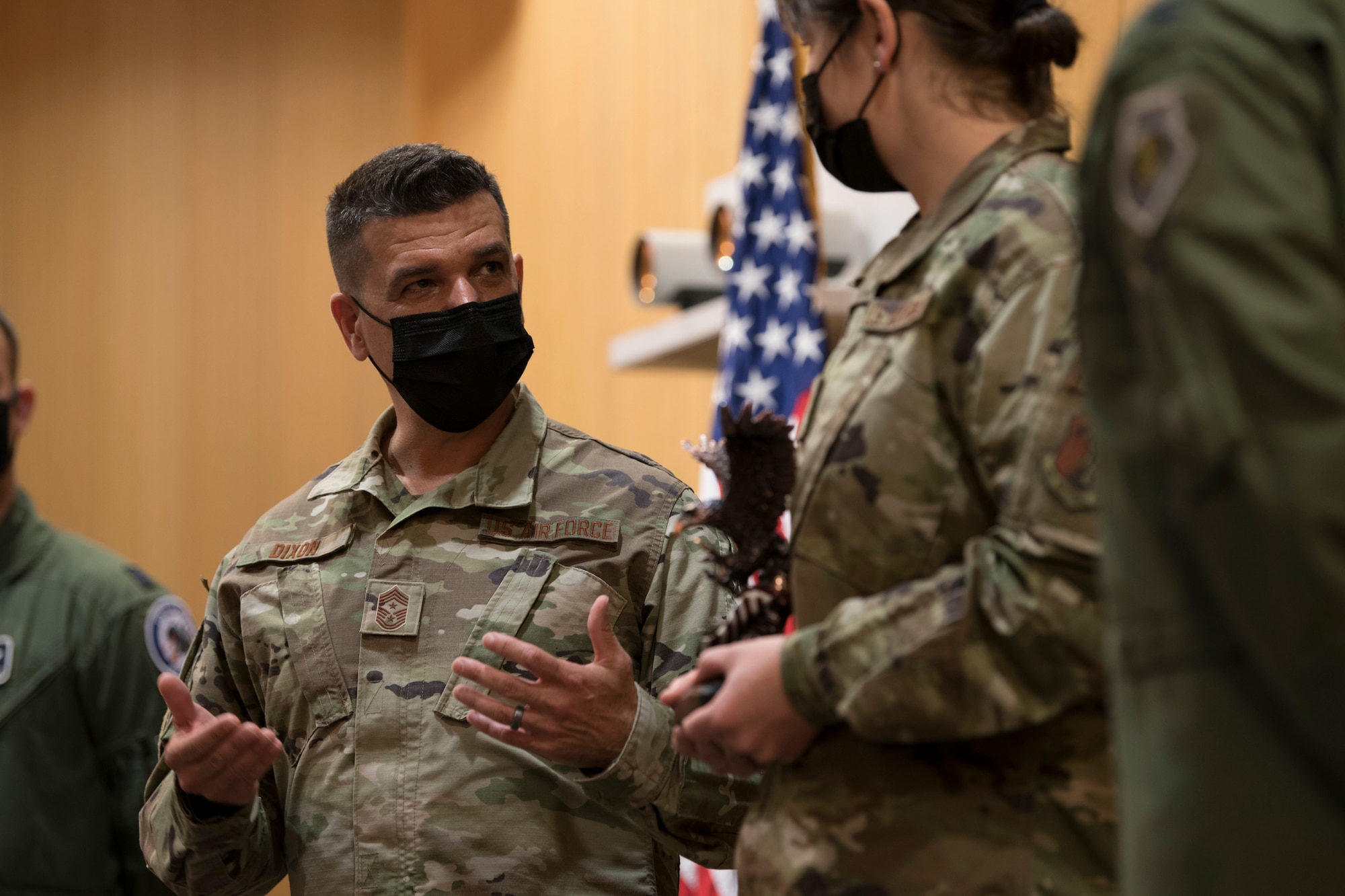 U.S. Air Force Chief Master Sgt. Michael E. Dixon, command chief, left, and Senior Airman Jacquline Graves, Aircrew Flight Equipment (AFE) journeyman, both assigned to the 122nd Fighter Wing, Indiana Air National Guard, take part in a ceremony to present the Air National Guard Outstanding AFE Airman of the Year award and the Air Force Achievement Medal April 24, 2021. Graves received the awards for spearheading a maternity flight suit project, shifting the paradigm for female fitment and aviation across the entire Air Force. (U.S. Air National Guard photo by Staff Sgt. Justin Andras)