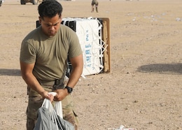 Rigger Spc. Andres Sanchez with the Fort Bragg, North Carolina, based 151st Quartermaster Company, deployed to the U.S. Central Command area of responsibility in support 1st Theater Sustainment Command, collects the rigging lines from one of the four parachutes that successfully carried bundles within 75 meters of the target at the Camp Buehring, Kuwait, drop zone April 22, 2021 using the Joint Precision Air Delivery System, or JPADS. Sanchez said he appreciated the chance to participate in the real-world exercise.