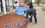 Staff members of the Fort Lee Family Advocacy Program set up signage and their annual pinwheel garden display by the front entrance of the Army Community Service facility to mark the start of Child Abuse Prevention Month on April 1. Pictured from left are FAP Specialist LaKetia Jones and New Parent Support Program Specialists Georgette Nelson and Teresa Mitchell. (U.S. Army Photo by Patrick Buffett)