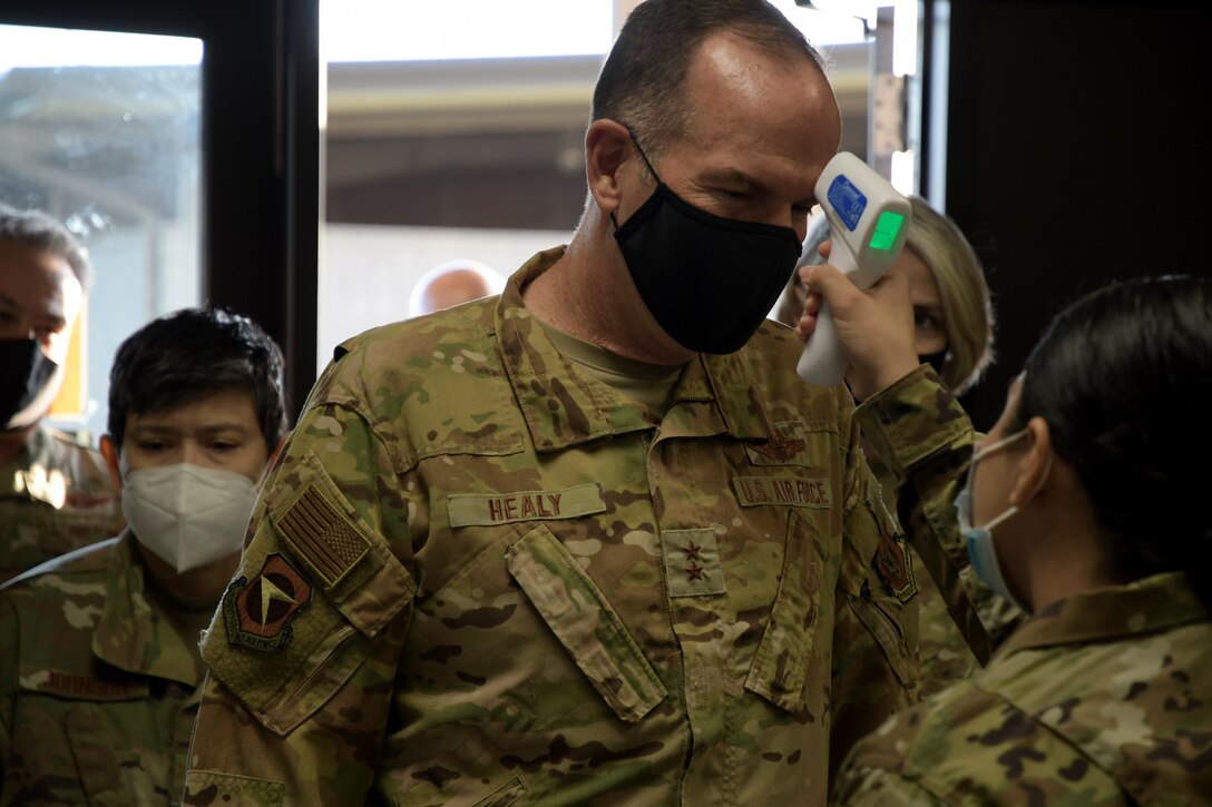 Maj. Gen. John P. Healy, 22nd Air Force commander, receives a temperature check during a tour at Dobbins Air Reserve Base, Ga, on April 11, 2021. (U.S. Air Force Photo by Staff Sgt. Justin Clayvon)