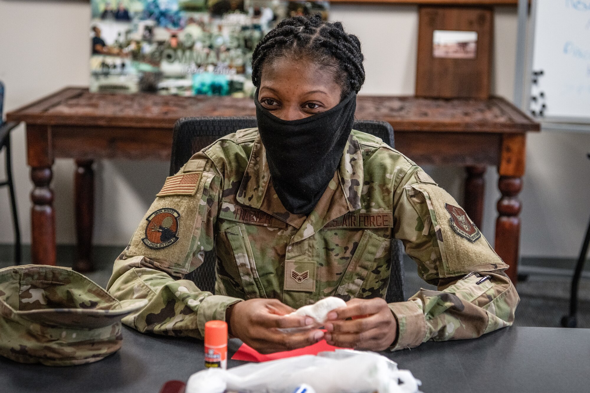 A female Airman molds a piece of clay.