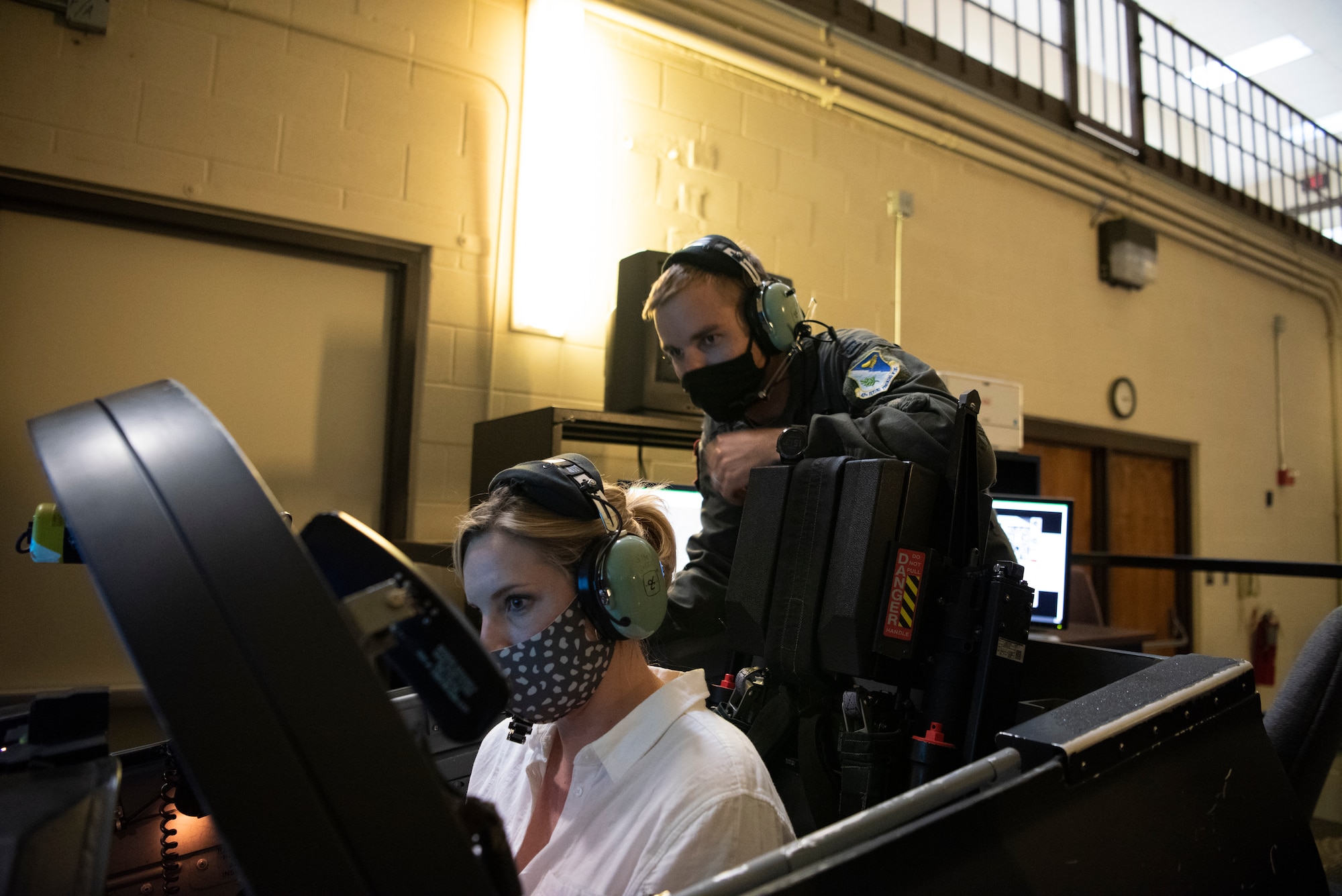 U.S. Rep. Ashley Hinson and Capt John Benton, 87th Flying Training Squadron Instructor Pilot, pilot a T-38 Simulator, on April 8, 2021 at Laughlin Air Force Base, Texas. The representives  learned how Laughlin trainees gained experience by learning how to fly simulators. (U.S. Air Force photo by Senior Airman Nicholas Larsen)