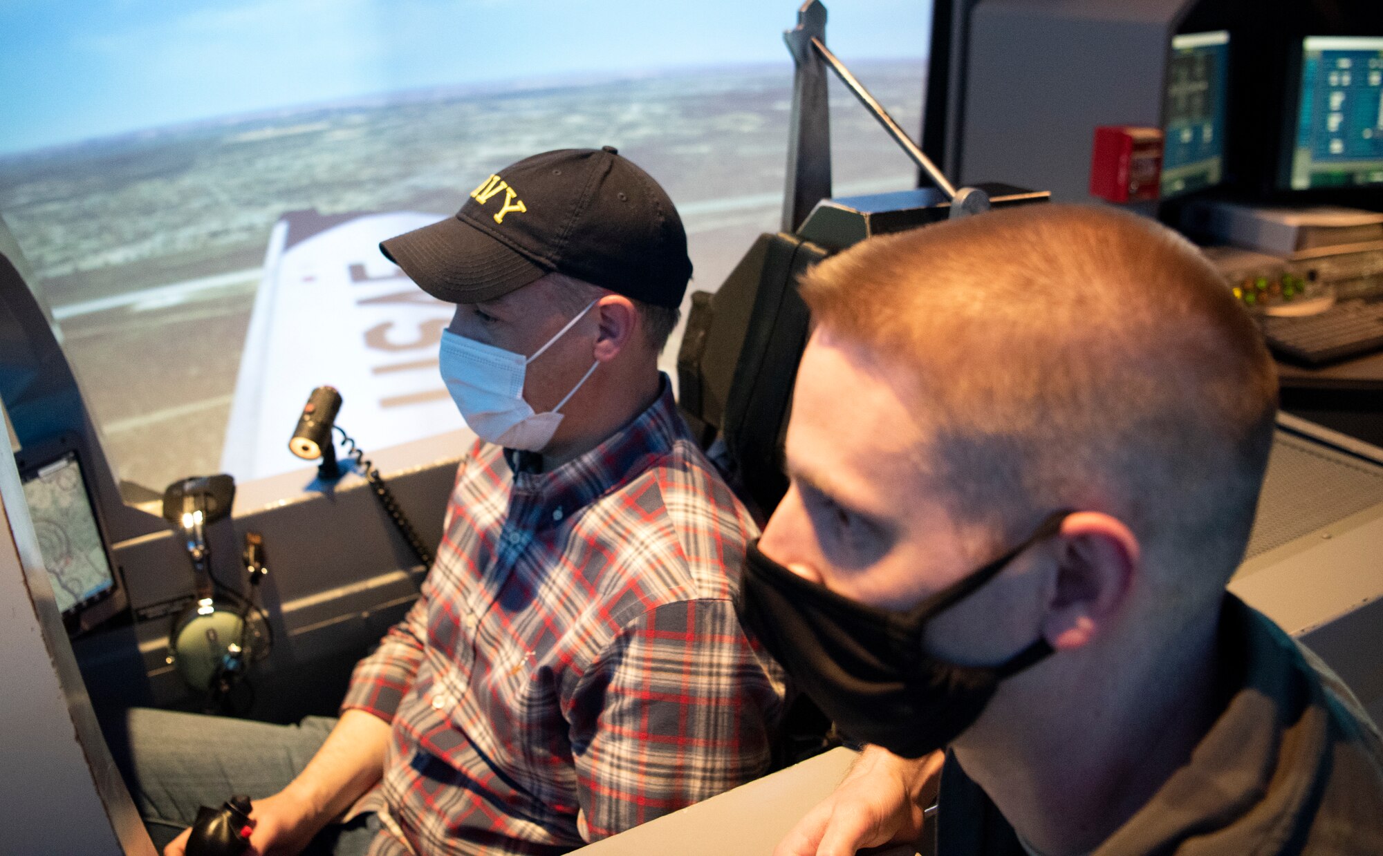 U.S. Rep. Jim Banks and Capt Neal Molzon, 85th Flying Training squadon instructor iilot, pilot a T-6 Simulator, on April 8, 2021 at Laughlin Air Force Base, Texas.   The representives  learned how Laughlin trainees gained experience by learning how to fly simulators. (U.S. Air Force photo by Senior Airman Nicholas Larsen)
