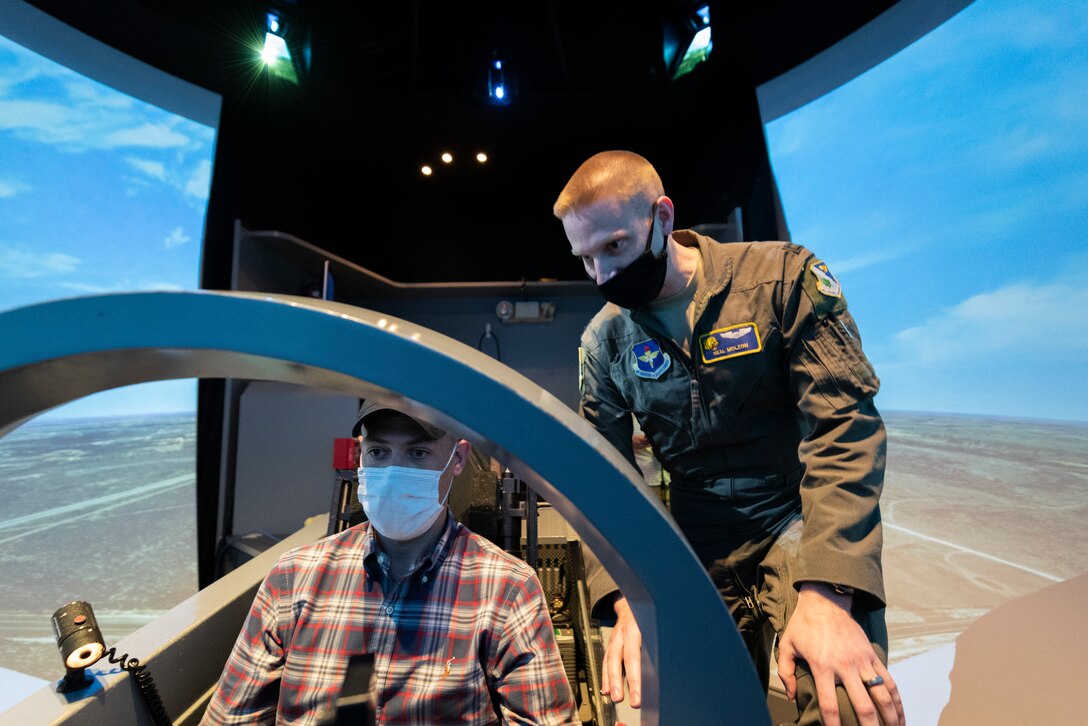 U.S. Rep. Jim Banks flies a T-6 Texan II simulator with the guidance of Capt. Neal Molzon, 85th Flying Training Squadron assistant director of operations and instructor pilot, on April 8, 2021 at Laughlin Air Force Base, Texas. The group of congressional members experienced how Team XL trains combat-ready Airmen, leaders and pilots through a hands-on trail of the simulators with the direction of the instructor pilots who mold future generations of aviators. (U.S. Air Force photos by Senior Airman Anne McCready)