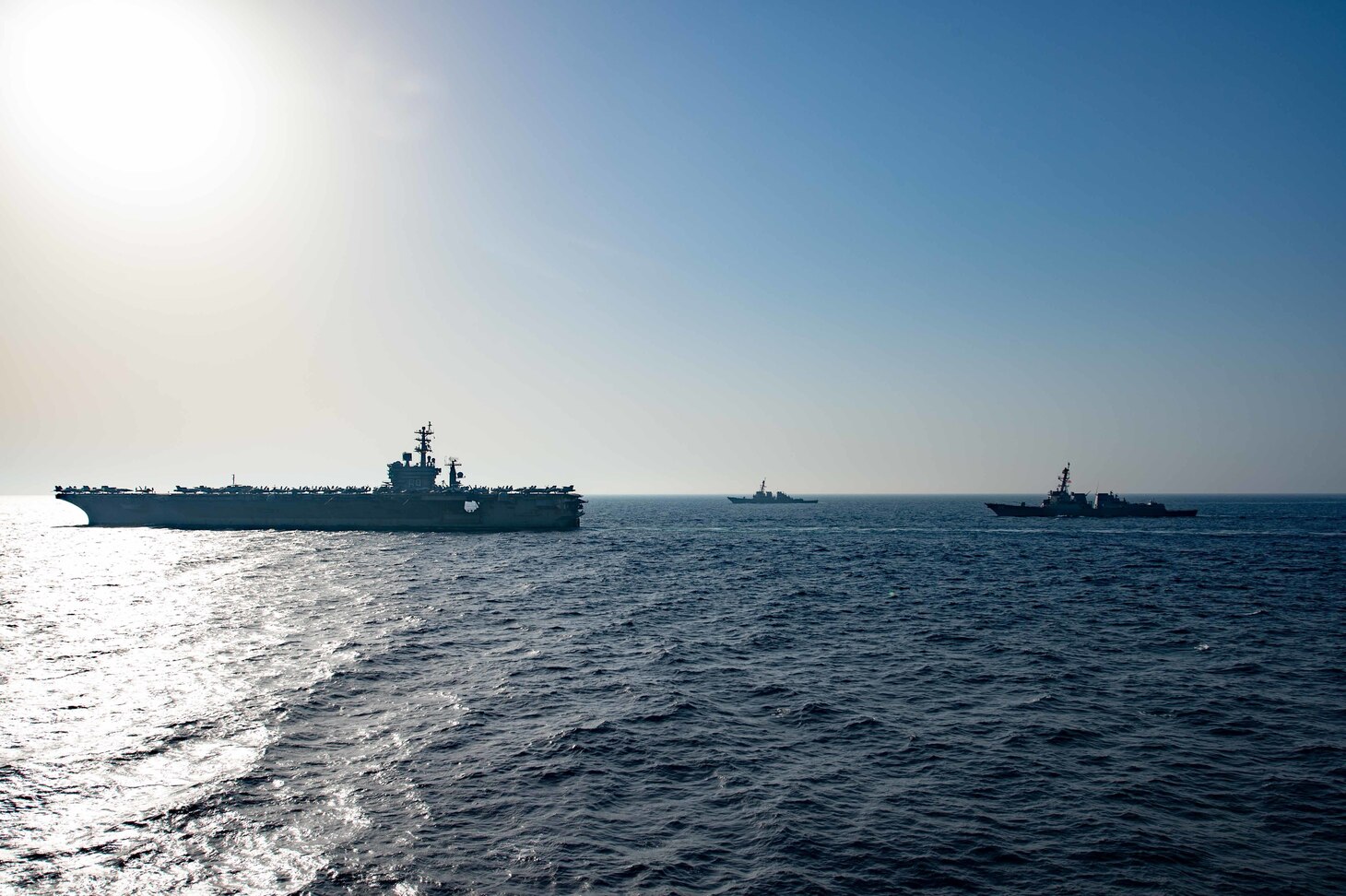 The aircraft carrier USS Dwight D. Eisenhower (CVN 69), left, the guided-missile destroyer USS Laboon (DDG 58), center, and the guided-missile destroyer USS Thomas Hudner (DDG 116) operate in formation in the Arabian Sea.