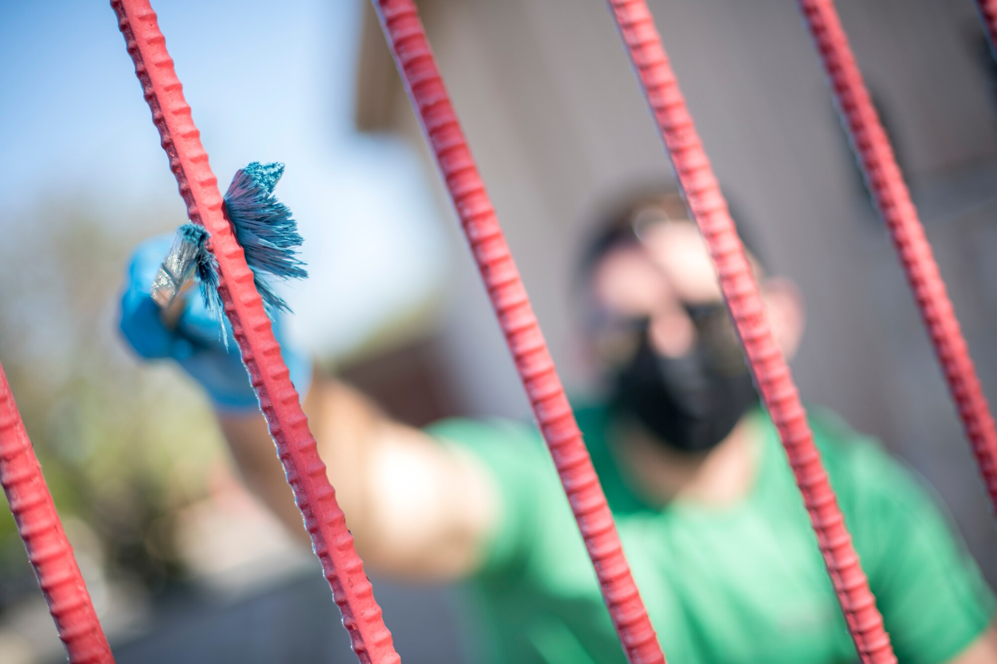 Second Lt. Drake Martin, 47th Student Squadron student pilot, paints San Felipe Creek fencing during “STUS Serve Day”, on April 10, 2021, in Del Rio, Texas. To give back to the local community, over two dozen STUS painted fences along the creek to provide the community a fencing which is visibly refreshed and renewed. (U.S. Air Force photo by Staff Sgt. Collette Brooks)