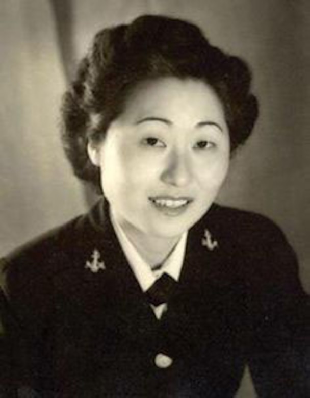 A woman in uniform smiles for the camera.