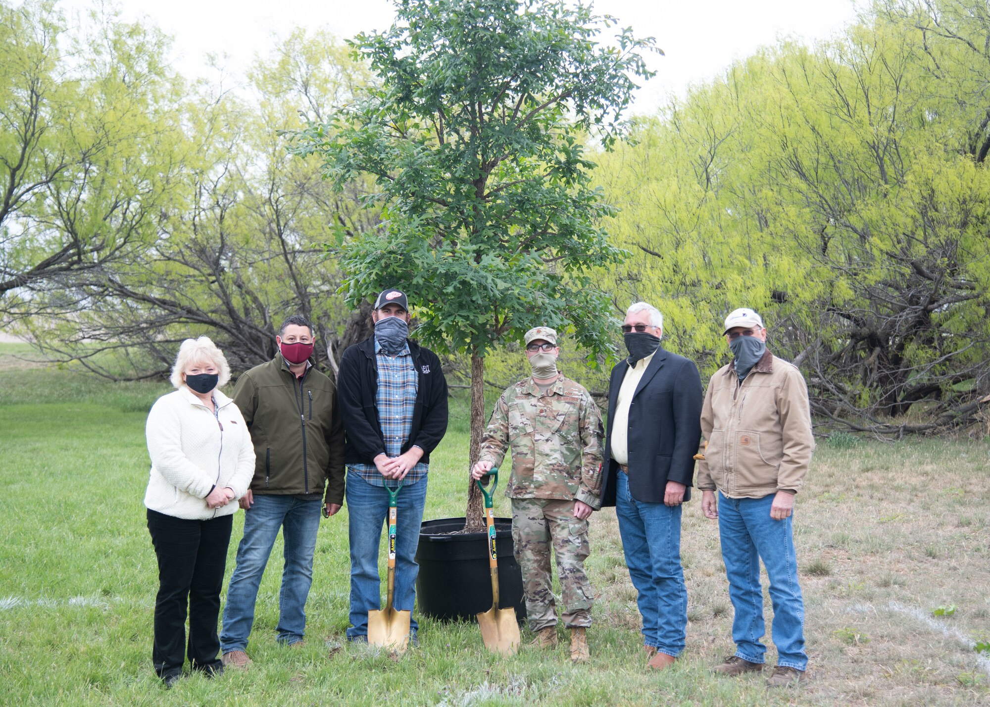 Members of the 17th Civil Engineer Squadron pose with a Bur Oak on Goodfellow Air Force Base, Texas, April 21, 2021. The team planted the Bur Oak to support Earth Day 2021, which is an environmental movement that raises awareness about ways to maintain a clean habitat. (U.S. Air Force photo by Staff Sgt. Tyrell Hall)